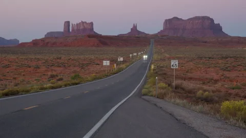 4K blurred motion Time lapse of dawn car light streaks in Monument Valley Stock Footage 253305622
