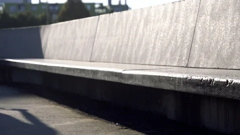 4K BMX biker doing trick on a concrete bench in park Stock Footage 117723876