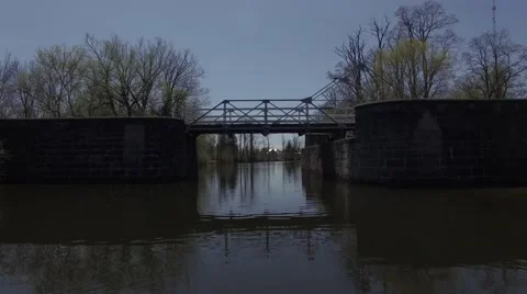 4k boating underneath bridge locks Stock Footage 63067831