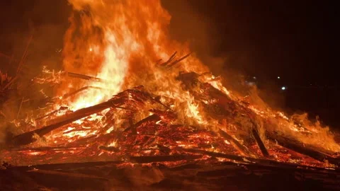 4K bonfire burning at night in Killarney with glowing flames, sparks, smoke and Stock Footage 336314080