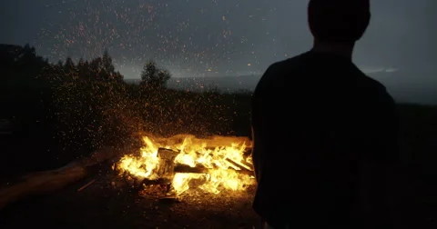 4K: Bonfire scene/Man Throwing Palette on Fire/Sparks Stock Footage 63152710