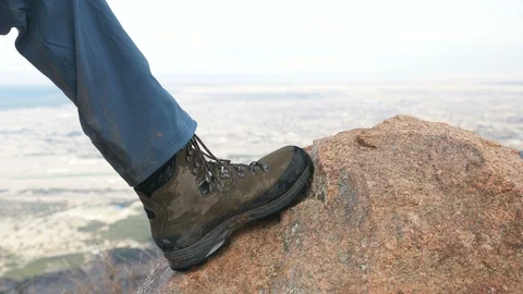 4K - Boot Being Placed onto Boulder High Altitude Stock Footage 105357168
