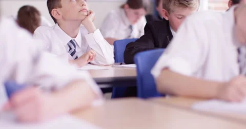 4k Bored school boy day dreaming during a class. Stock Footage 62973093