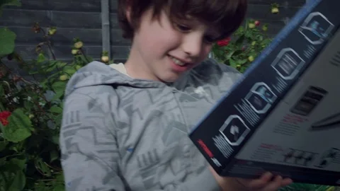 4K Boy Opening his Cardboard Box with Airplane Toy Stock Footage 80238267