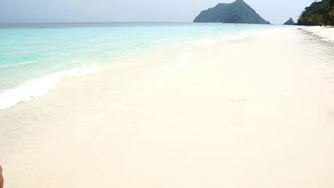 4k Boy running on a white sand beach with crystal clear blue Andama sea Stock Footage 87737883