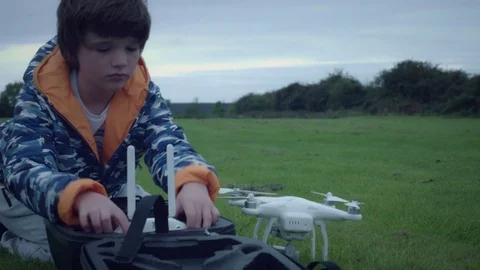 4k Boy Setting up Big Drone and Remote Control Stock Footage 80301983
