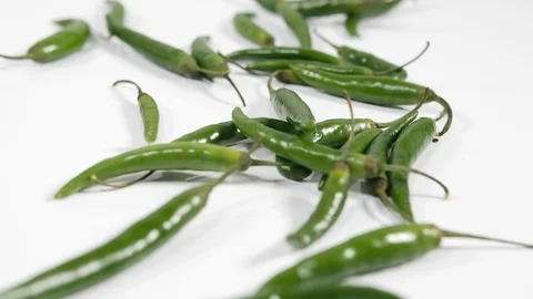 4K bright green chilli peppers focus pull against white background  Stock Footage 88490079