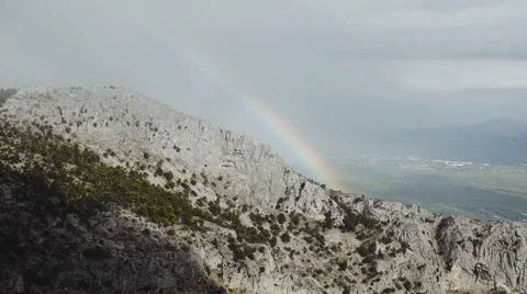 4K bright rainbow over cliff,mountain landscape,fog coming Stock Footage 67819973
