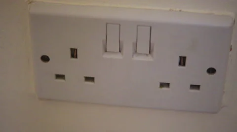 4K British black electric plug is plugged into white wall socket Stockbeeldmateriaal 51822790