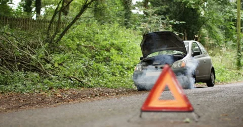 4K Broken down car with smoking engine left abandoned on quiet country road Stock Footage 68311874