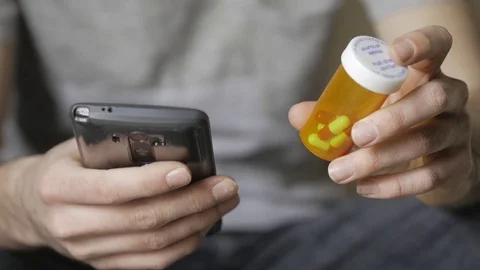 4K Browsing Smartphone With Pills Medication Bottle In Hand Видео 73382064