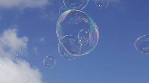 4K Bubbles floating along on the breeze, in slow motion Stock Footage 55912176
