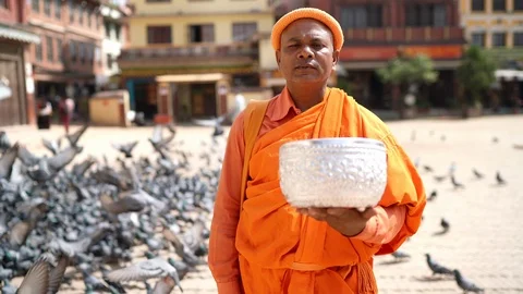 4K Buddhist monk standing on square holding ceremonial bowl Stock-Footage 123610105