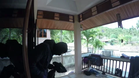 4K. Burglar in Mask Commit A Crime and Rob A House. Video stock 67487403