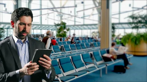 4K Business Man in Airport Terminal Waiting Area Uses iPad Tablet Computer Stock Footage