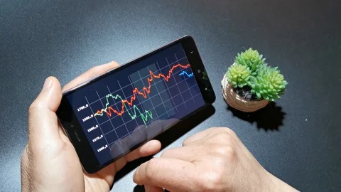 4K Business man checking stock market data on smart phone. Stock market data Stock Footage 128829052