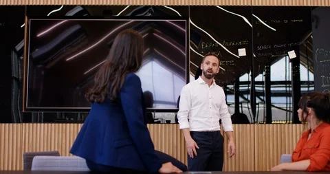 4K Business manager with aggressive attitude in a meeting with female colleagues Stock Footage 118769244