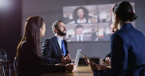 4K Business team connected to multiple colleagues on split screen video call 動画素材 104233253
