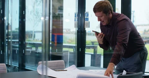 4K Businessman in boardroom discussing data from sales report over the phone Stock Footage 118936039