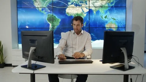4K Businessman having conversation via headset with world map in background Stock Footage 75952978