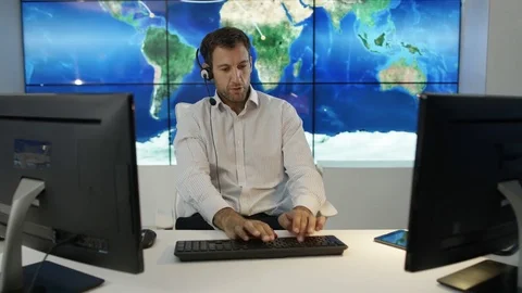 4K Businessman having conversation via headset with world map in background Stock Footage 75953191