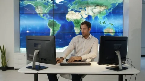 4K Businessman having conversation via headset with world map in background Video stock 75954772