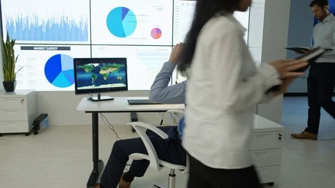 4K Businessman interacting with a virtual reality headset in futuristic office Stock Footage 75977640