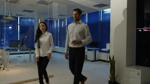 4K Businessman interacting with a virtual reality headset in futuristic office Stock Footage 75981309
