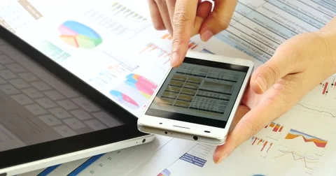 4k Businessman search information on ipad,study financial data on smartPhone. Video stock 48986763