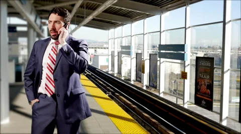 4K Businessman in Suit Talking on Mobile Cellphone at City Train Platform Video stock 60057760