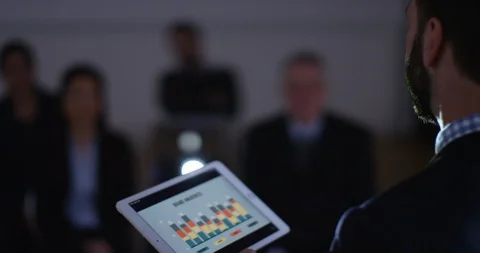 4K Businessman using animated sales graph to give a presentation to colleagues Stock Footage 104646526