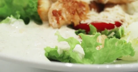 4k Caesar salad with chicken, vegetables, eggs, lettuce, sauce, parmesan cheese Stock Footage 78193451