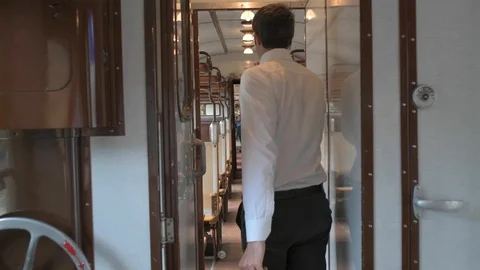 4K camera following a passanger walking down the corridor in vintage train Stock Footage 90807852