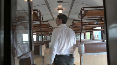 4K camera following a passanger walking down the corridor in vintage train Stock Footage 90807878