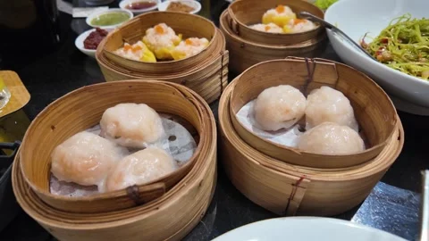 4K Camera footage Assorted steamed dim sum in bamboo baskets Stock Footage 325649666