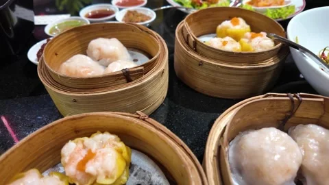 4K Camera footage Assorted steamed dim sum in bamboo baskets Stock Footage 325649671