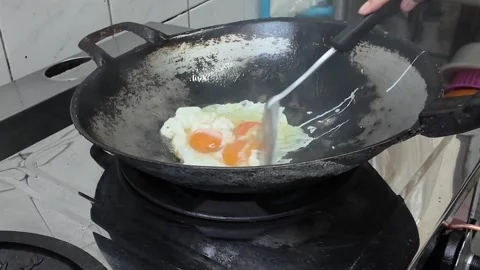 4K Camera footage Eggs frying on hot wok in kitchen 스톡 동영상 325649586