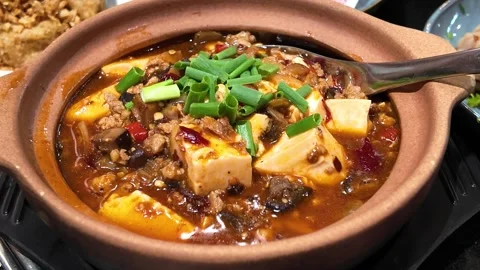 4K Camera footage Spicy mapo tofu in clay pot with garnish Stock Footage 325649657