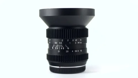 4k - Camera lens rotating on white background Video stock 71897111