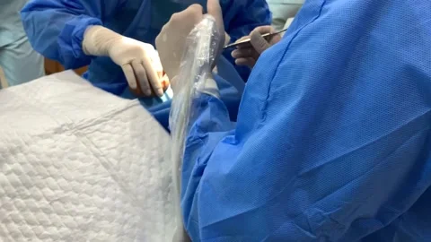 4k Camera panning of dentist and dental assistant during dental implant surgery Stock Footage 135852343