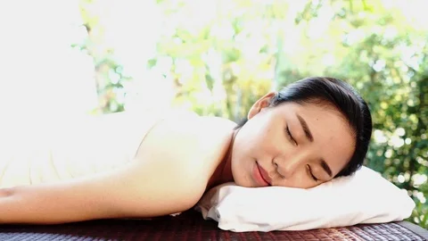 4k Camera panning Happy Young Asian Thai woman resting on a spa bed in  Stock Footage 87236965