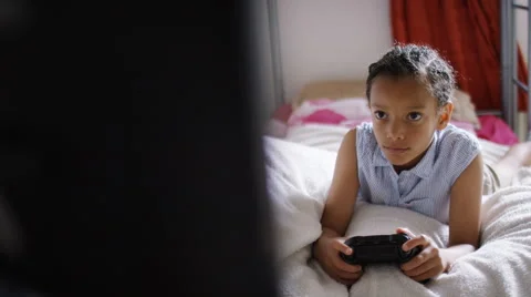 4K Camera reveals young child playing video games, in slow motion Stock Footage 64723697