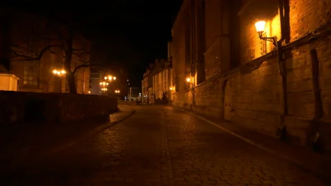 4K - Camera slowly moves through the old European city at night Stock Footage 131557050