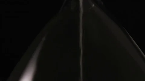 4K Camera tilts down to see sand gathering at the bottom of a sand timer Stock-Footage 71255346