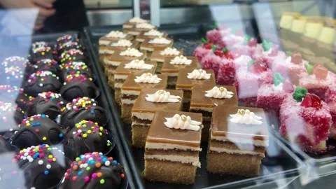 4K Camera video of assorted cakes and desserts in glass display Stock Footage 325720661