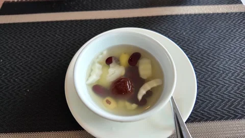4K Camera video of Chinese herbal dessert soup in white bowl Stock Footage 325720737