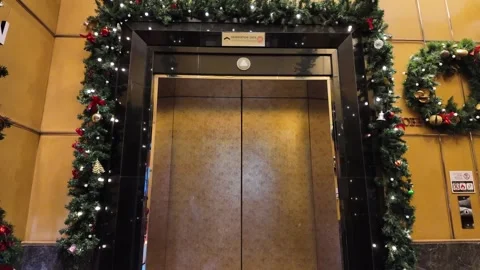 4K Camera video of elevator entrance decorated with Christmas lights Stock Footage 325789937