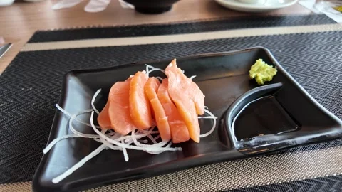 4K Camera video of fresh salmon sashimi with wasabi on black plate 스톡 동영상 325720721