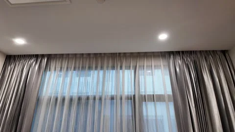 4K Camera video of grey curtains with soft daylight filtering through window Stock Footage 325720536