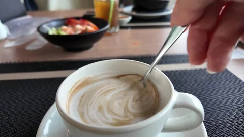 4K Camera video of hand stirring hot coffee with spoon Stock Footage 325720726